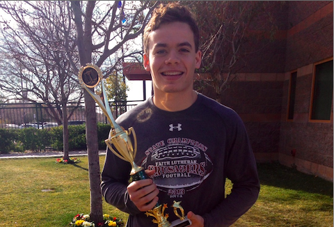 Jacob Deaville, holding the award the team won before presenting it to Mr. Fogo.