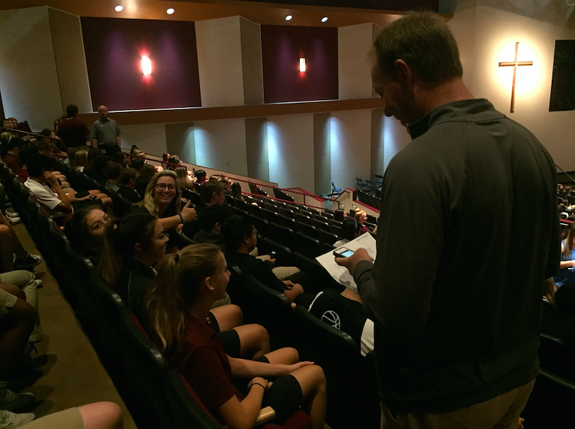 Mr. Neagle, Physical Education Teacher, takes attendance before Chapel begins.