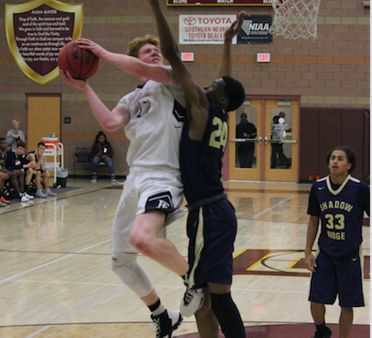 Junior forward, Elijah Kothe, drives the ball to the basket against the Mustangs defense.