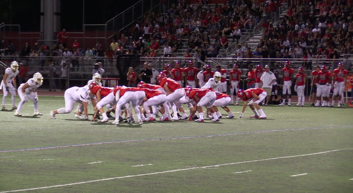 The Aggie offense gets ready to run a play against the Crusader defense.