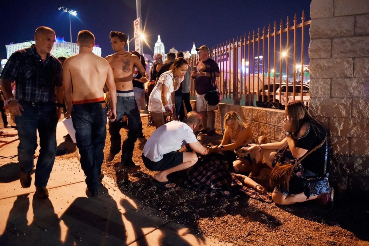 Festival goers attend to an injured after the attack.