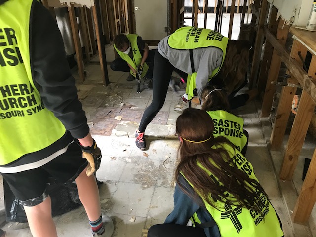 Students work hard to repair a Houston home damaged immensely by the recent hurricane. 