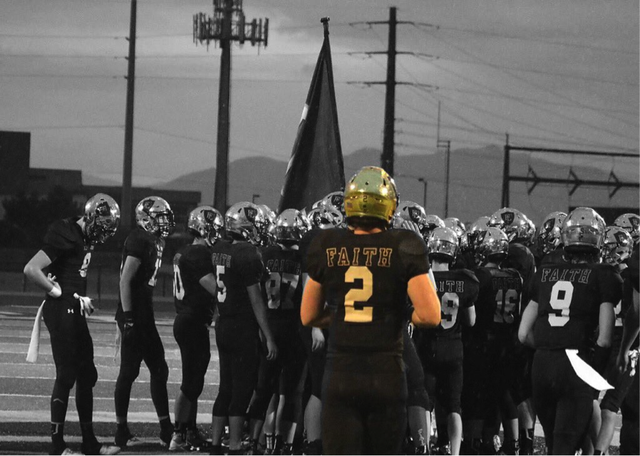 Nate Meredith, number 2, huddles with fellow teammates at a home football game this season. 