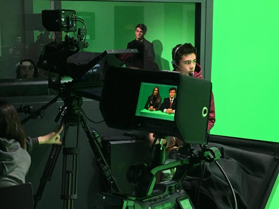 Studio camera operator Eric Ho counts Ian McFarlane down for his segment.