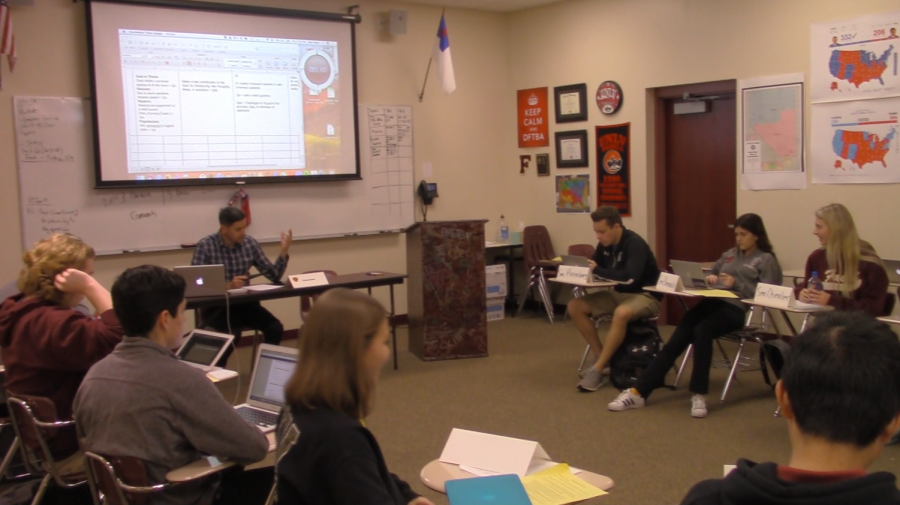 Advisor, Ryan Watts, leads his AP US Government class in a formal debate on a current issue in America