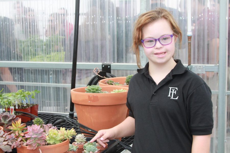 Mark 10:14 student, Antalya, examines plants in the new greenhouse. Mark 10:14 classes will utilize the greenhouse as a new teaching tool for the students.  