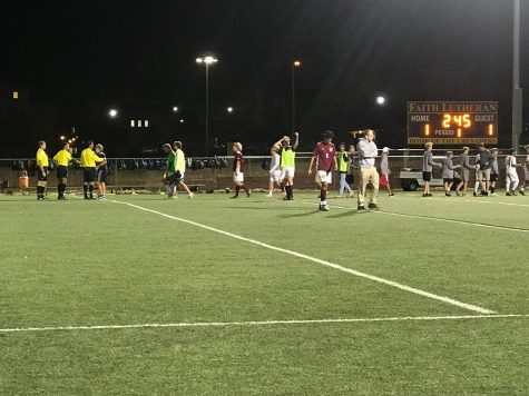 Both teams walk off the field after a match that took overtime to decide a victor.