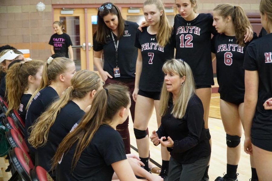 Amy Fisher gives the the Varsity Volleyball insightful advice during a timeout. 