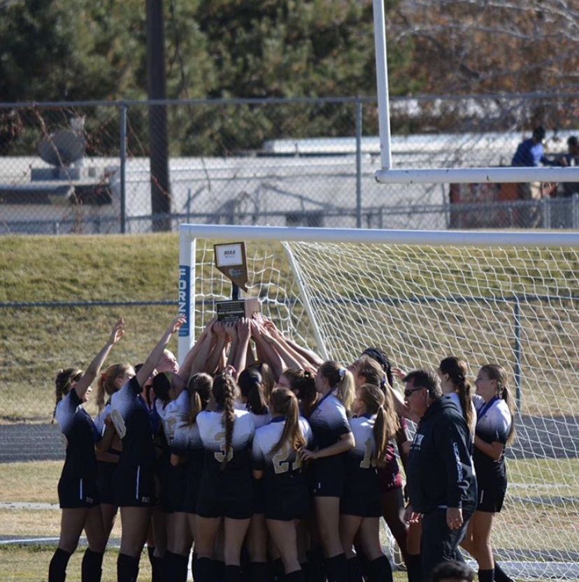 Moments after the big win, the girls soccer team prepare to bring the trophy home to Las Vegas. 