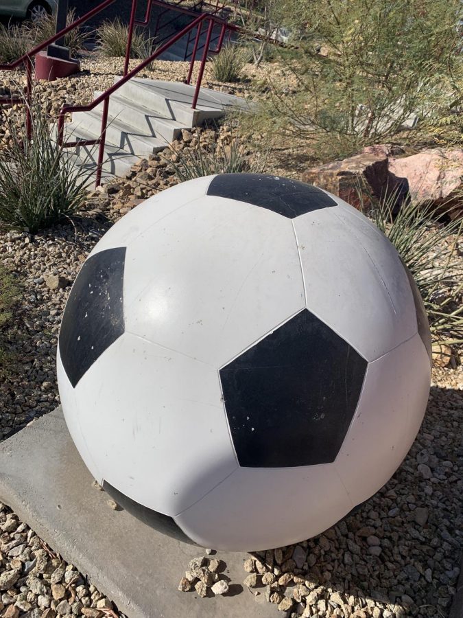 Soccer ball right outside the soccer field!