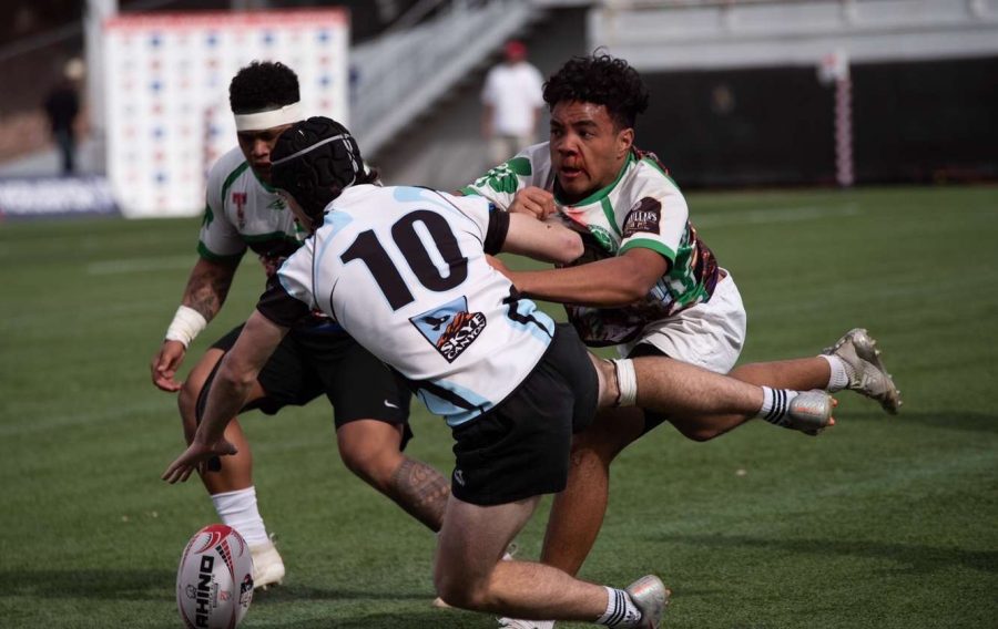 Flynn Martin, a senior at Faith, is going for the ball at a high school Rugby game. 