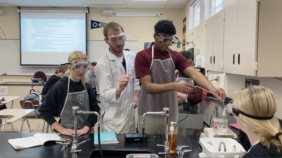 Mr. Egger works with students on an interactive lab.