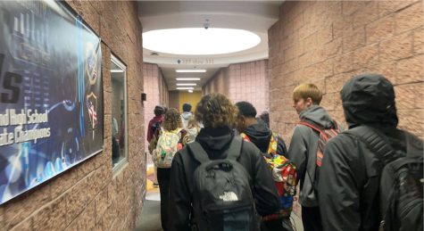 Students walking down the hallway. 