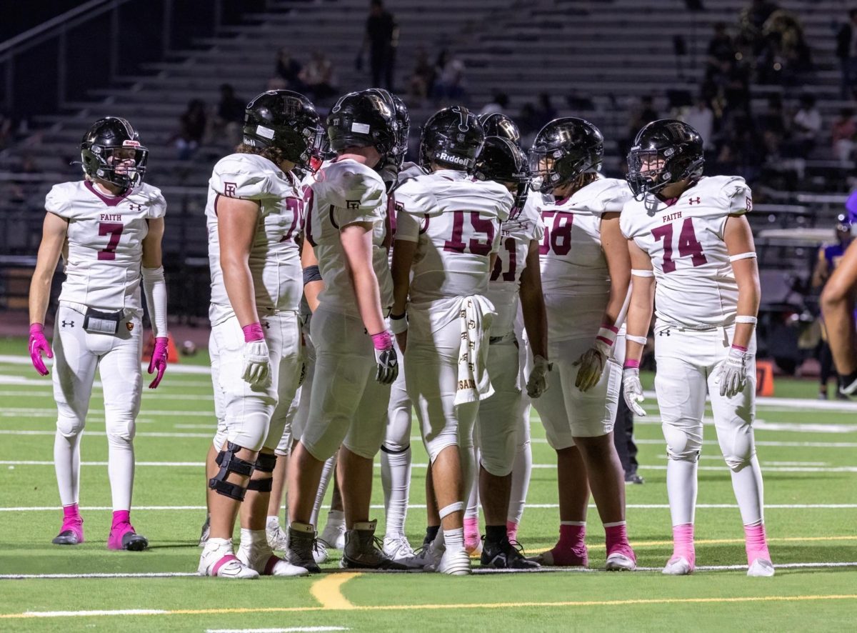 Crusaders huddle up to call an offensive play in a win against Durango. 