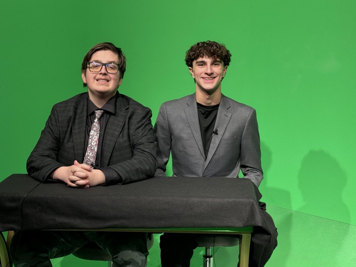 Director Cole Jessa tries his talents out on the anchor desk along with Brennan Rosenberg.